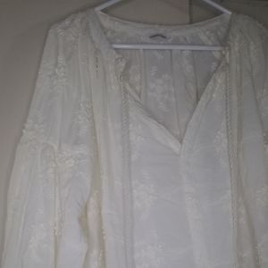 Off white peasant blouse with beautiful embroidery and gypsy closed sleeves.Sz L